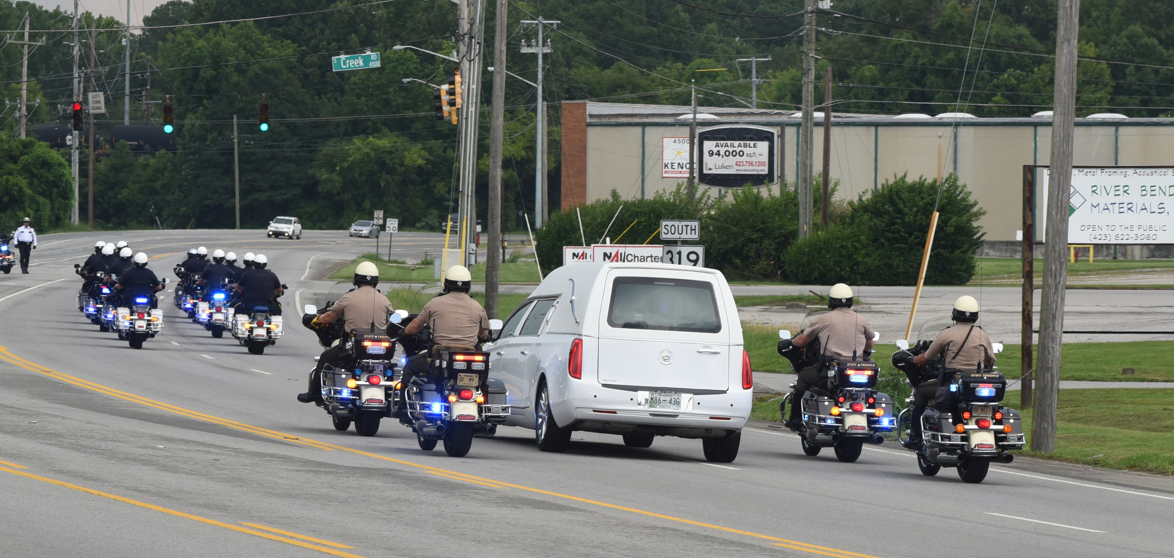 Members of the Tennessee Highway Patrol and the Chattanooga Police Department escort a hearse carrying the body of slain U.S. Navy Petty Officer Randall Smith on Amnicola Highway just past the U.S. Naval and Marine Reserve Center on Sunday, July 19, 2015, in Chattanooga, Tenn. Before the body was taken to the Chattanooga Metropolitan Airport for transport to Dover Air Force Base, the motorcade drove past both shooting scenes from last Thursday's terrorist attack that killed Smith and four Marines.