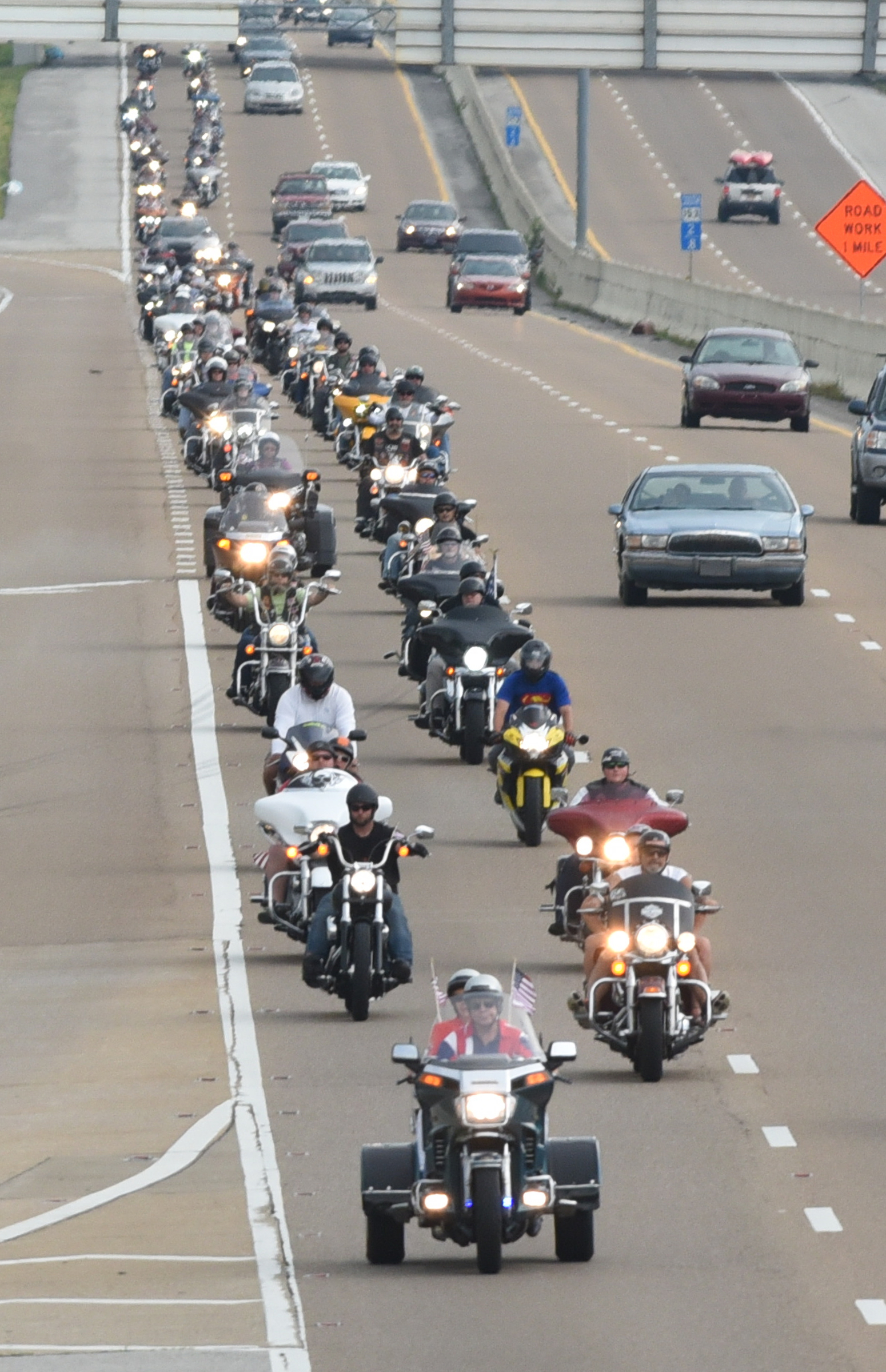 Motorcyclists travel on Highway 153 on Sunday, July 19, 2015, in Chattanooga, Tenn., as they ride from the Armed Forces Career Center on Lee Highway to the U.S. Naval and Marine Reserve Center on Amnicola Highway in the aftermath of a Thursday terrorist attack at those two facilities that killed four Marines and one member of the U.S. Navy.