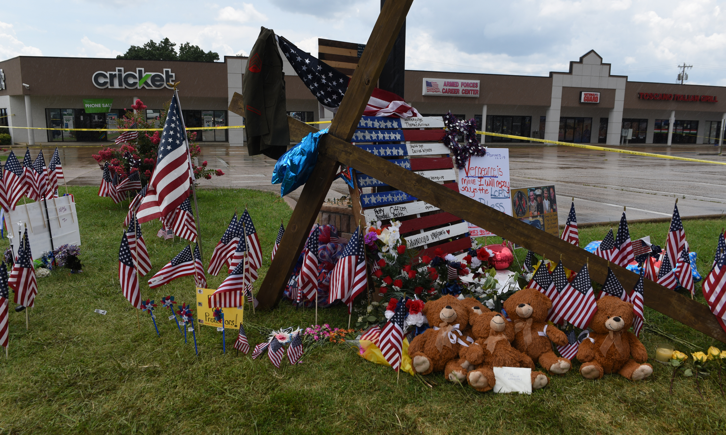 Seen on Sunday, July 19, 2015, in Chattanooga, Tenn., crosses, flags, signs, stuffed animals and other mementos make up a memorial in front of the Armed Forces Career Center on Lee Highway in the aftermath of a Thursday terrorist attack that killed four Marines and one member of the U.S. Navy.