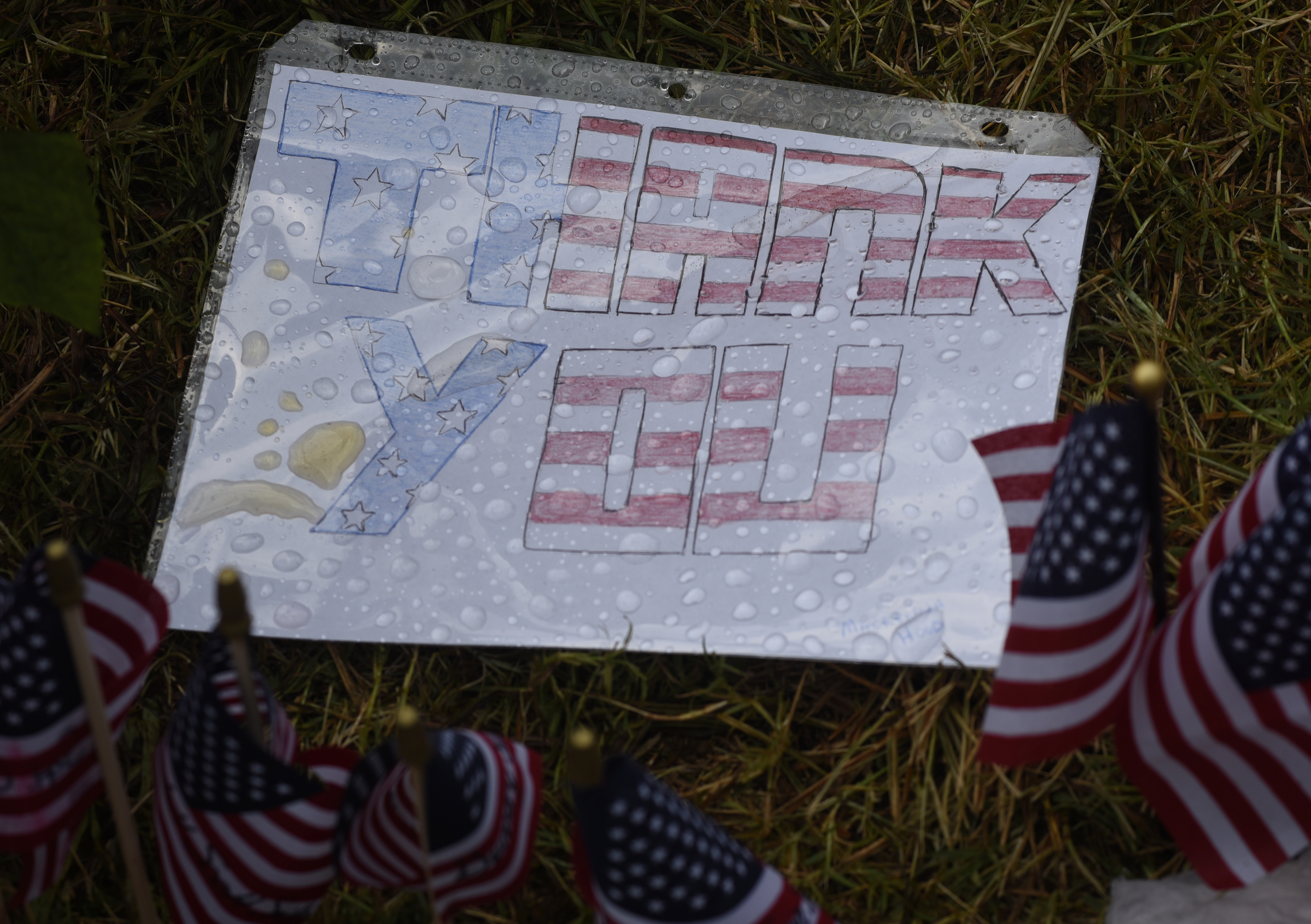 A sign reads "thank you" at the makeshift memorial at the Armed Forces Career Center on Lee Highway seen Sunday, July 19, 2015, in Chattanooga, Tenn. A Thursday terrorist attack at two locations in Chattanooga killed four Marines and one member of the U.S. Navy.
