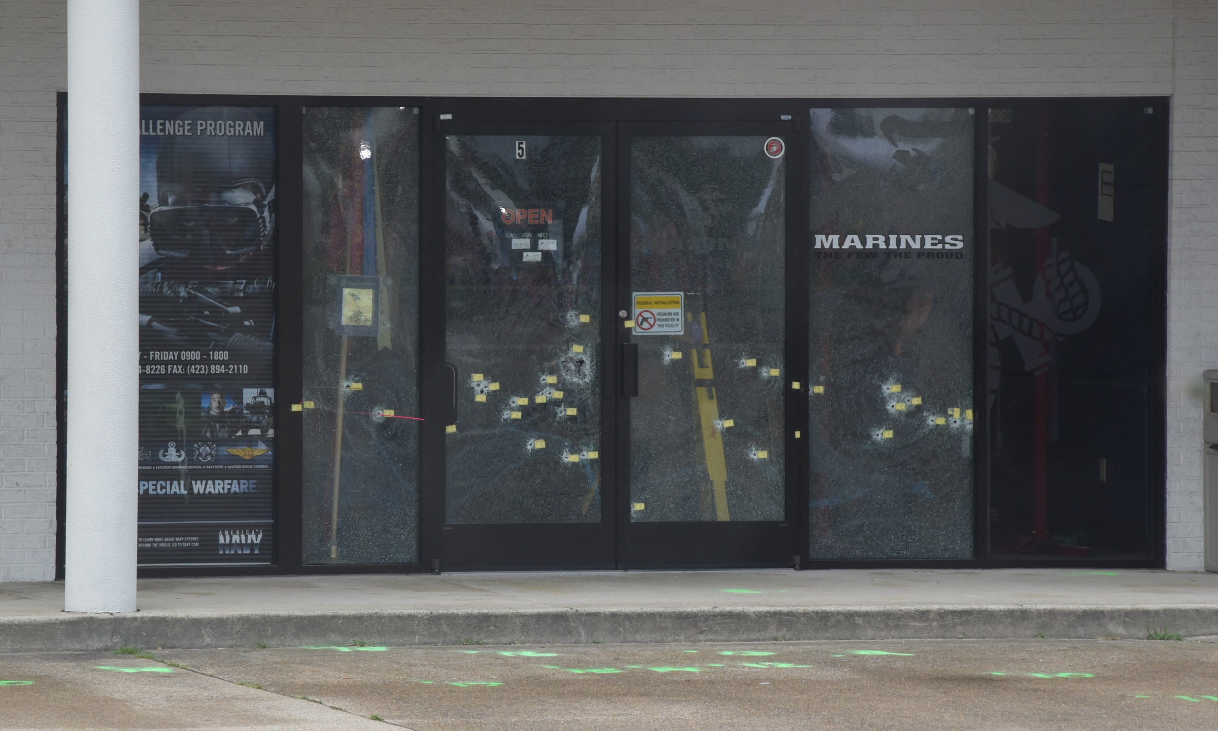 Bullet holes are still visible in the front windows of the Armed Forces Career Center on Lee Highway on Sunday, July 19, 2015, in Chattanooga, Tenn., in the aftermath of a Thursday terrorist attack that killed four Marines and one member of the U.S. Navy.