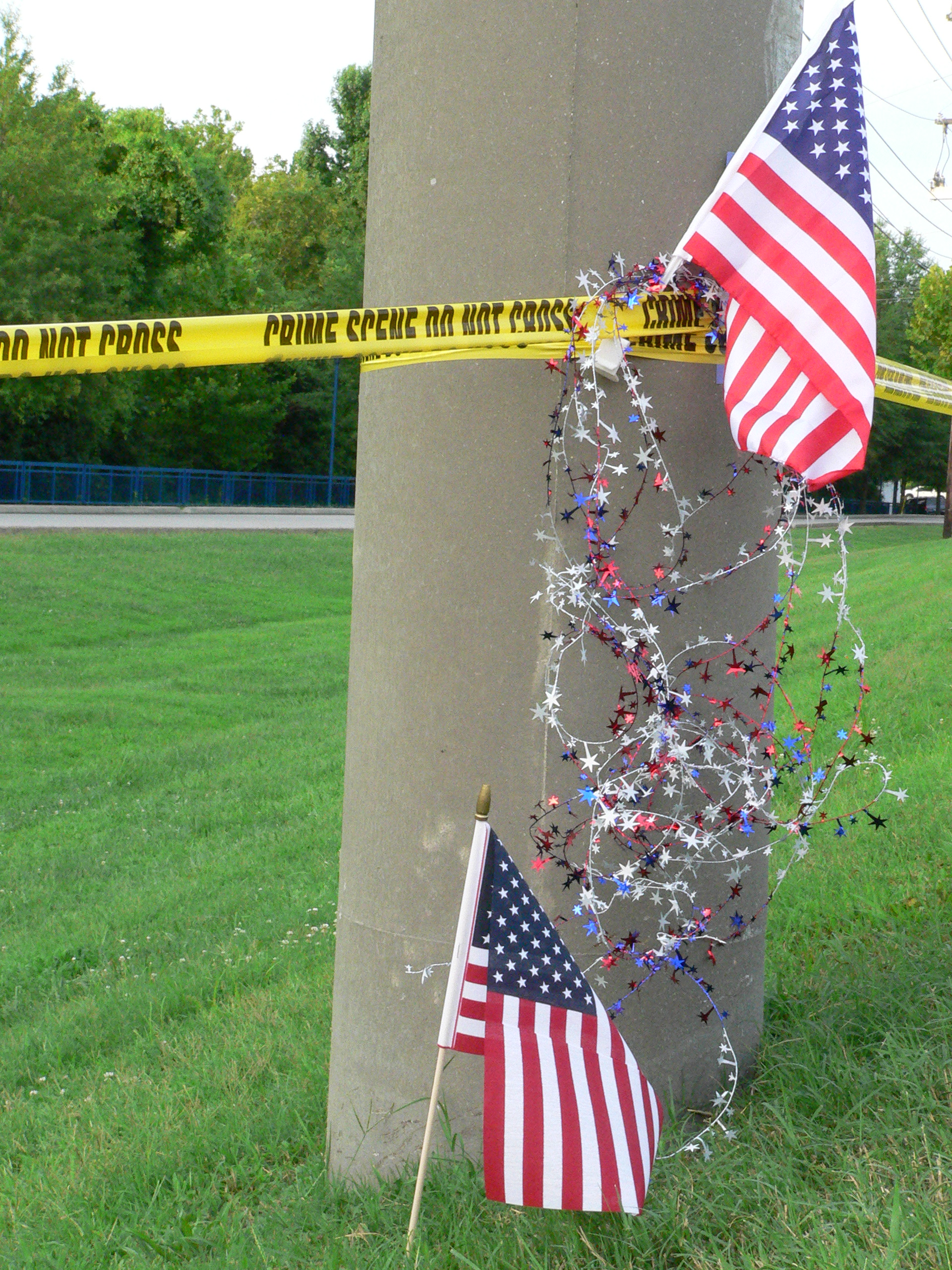 At the memorial for slain military members on Amnicola Highway. The car in the background on the right is parked at the entrance to the Navy/Marine operations center where four Marines and a Navy petty officer were shot to death.