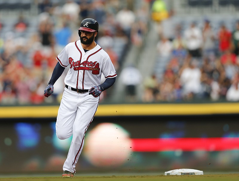 Atlanta Braves' Nick Markakis rounds second base after hitting a two-run home run in the first inning of a baseball game against the Los Angeles Dodgers Monday, July 20, 2015, in Atlanta. (AP Photo/John Bazemore)