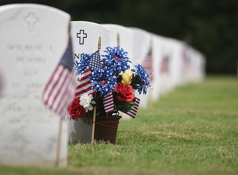 Flowers decorate a grave at the Chattanooga National Cemetery after the 2015 Memorial Day program.
