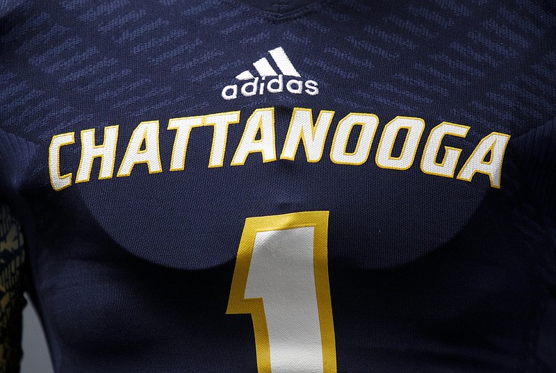 The adidas logo is seen above the Chattanooga logo on a uniform during a news conference to reveal the UTC football team's new Adidas uniforms Tuesday, July 21, 2015, at McKenzie Arena in Chattanooga, Tenn.