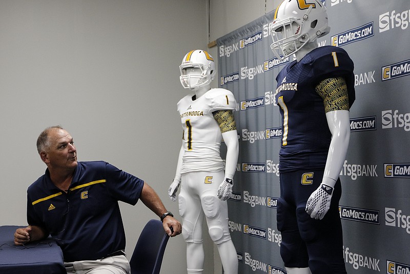 Head football coach Russ Huesman speaks during a news conference to reveal the UTC football team's new Adidas uniforms Tuesday, July 21, 2015, at McKenzie Arena in Chattanooga, Tenn.