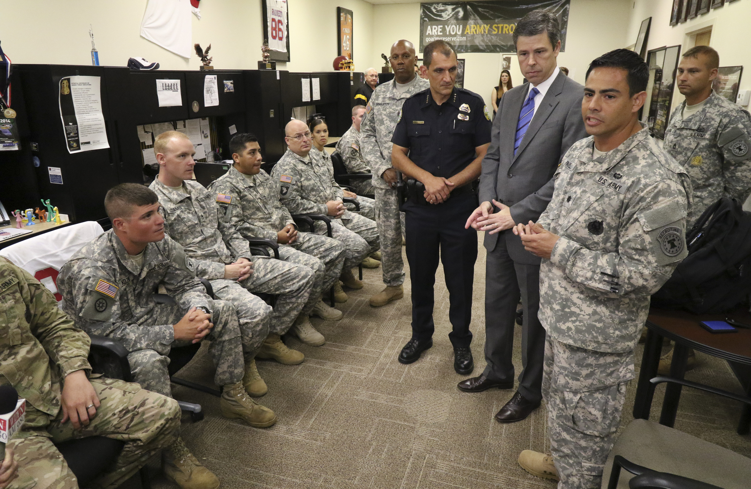 LTC Tony Parilli, right, thanks Chattanooga Mayor Andy Berke and Police Chief Fred Fletcher while at the Armed Forces Career Center off of Lee Highway on Tuesday, July 21, 2015 for the city's quick response during the July 16, 2015 terror shootings .