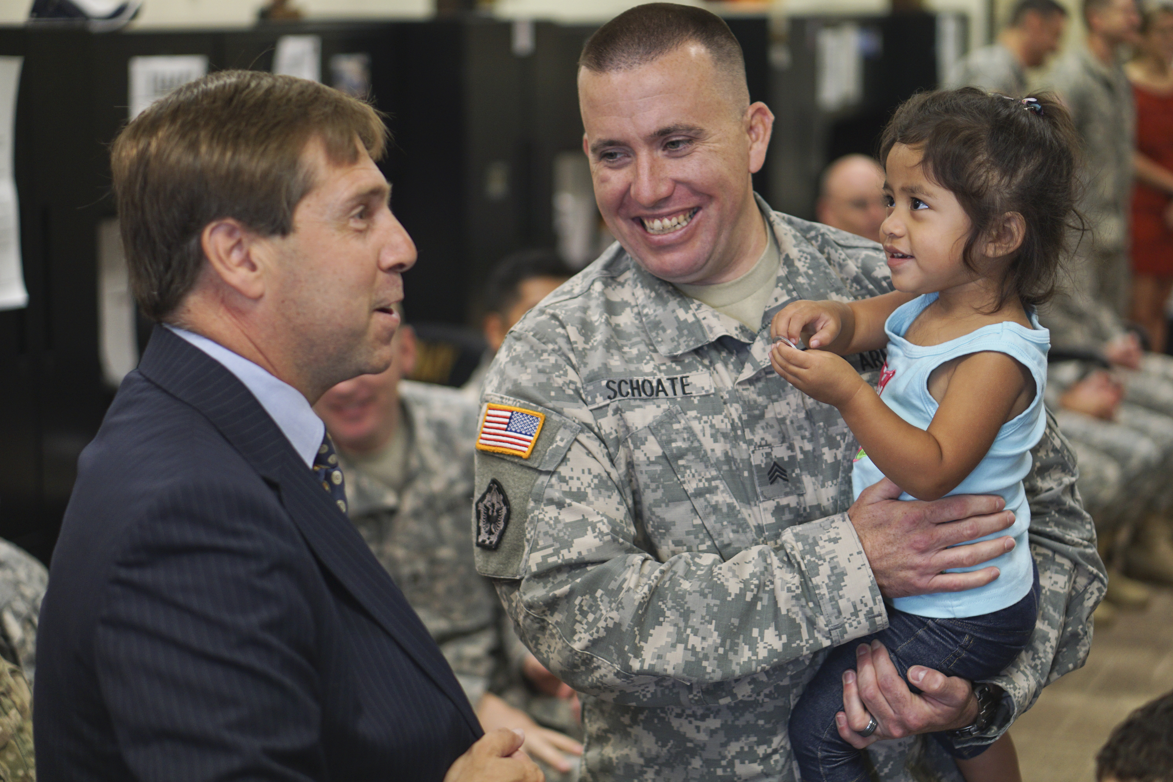 Congressman Chuck Fleischmann speaks to Chris Schote and his two-year-old foster daughter Anna while at the Armed Forces Career Center off of Lee Highway on Tuesday, July 21, 2015.
