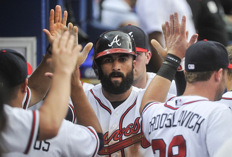 Atlanta Braves' Nick Markakis celebrates scoring against the Los Angeles Dodgers during the third inning of a baseball game Tuesday, July 21, 2015, in Atlanta.