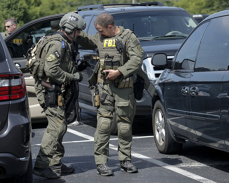 FBI agents prepare in a staging area on Hixson Pike before leaving to investigate the nearby home of gunman Muhammad Abdulazeez on Thursday in Chattanooga.