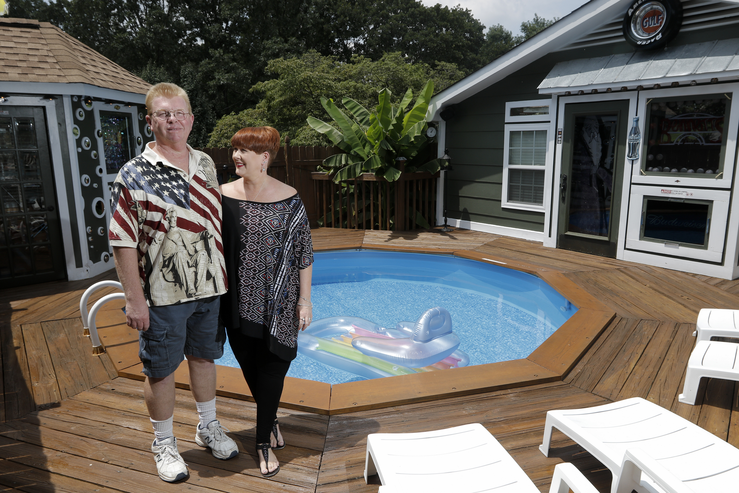 Larry and Shannon Bennett stand near their above-ground pool and deck work Saturday, July 18, 2015, at their home in Ooltewah, Tenn.