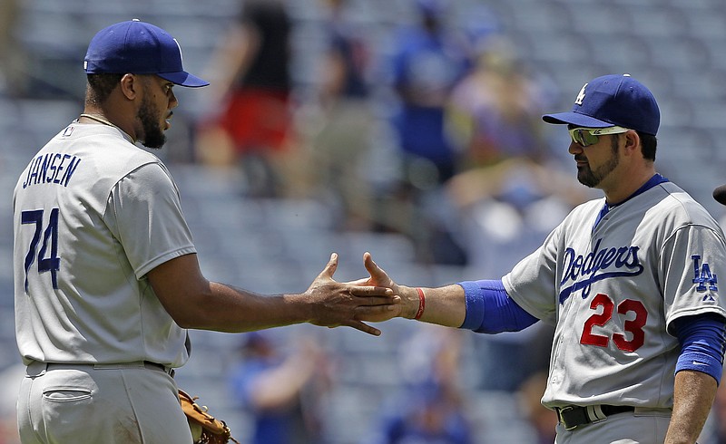 Los Angeles Dodgers relief pitcher Kenley Jansen (74) celebrates with first baseman Adrian Gonzalez (23) after they defeat the Atlanta Braves 3-1 in a baseball game, Wednesday, July 22, 2015, in Atlanta.