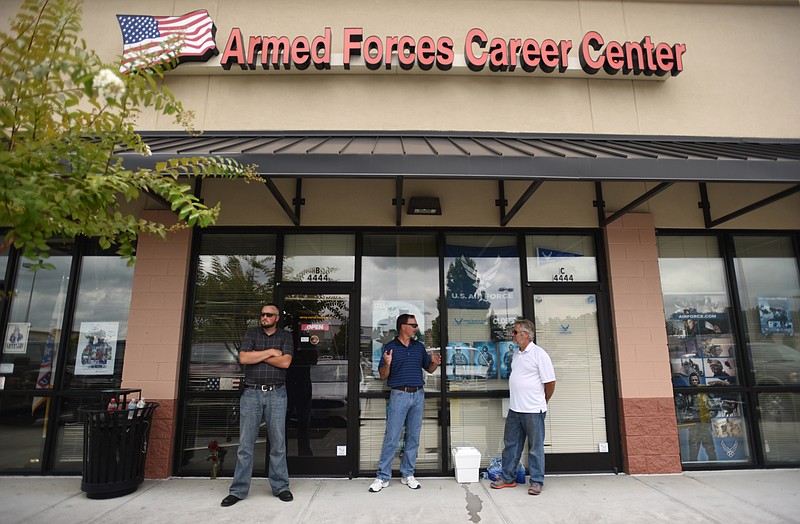 Nathan Bell, Sen. Mike Bell, R-Riceville, and Gary Church, from left, stand Thursday outside the Armed Forces Career Center in Cleveland.