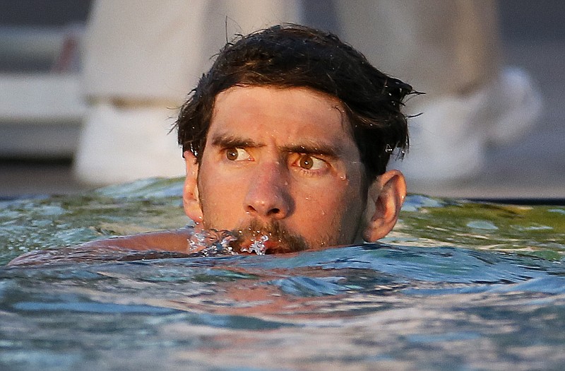 
              FILE - In this April 18, 2015, file photo, Michael Phelps looks to the scoreboard after competing in the men's 100 meter freestyle final at the Arena Pro Swim Series in Mesa, Ariz. Phelps finished first in the final. Phelps was banned from worlds as part of his punishment by USA Swimming for a second drunken driving arrest last fall. (AP Photo/Matt York, File)
            