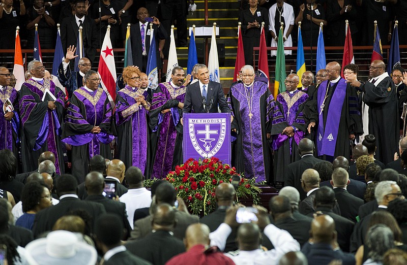 President Barack Obama leads a singing of "Amazing Grace" while delivering the eulogy at the funeral service for Rev. Clementa Pinckney, Friday, June 26, 2015, in Charleston, S.C. (AP Photo/David Goldman) 