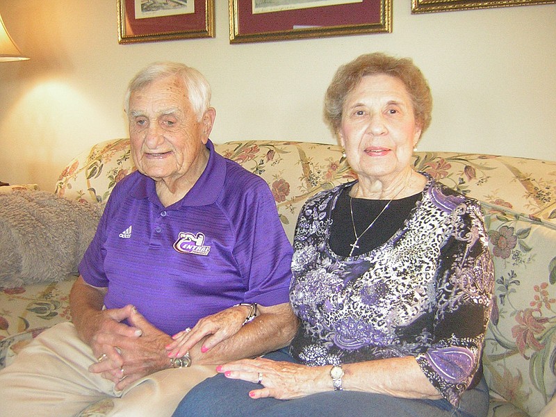 Connie Hay sits with his wife of 59 years, Naomi, in their home near Central High School, where he continues to help the football program at the age of 90.