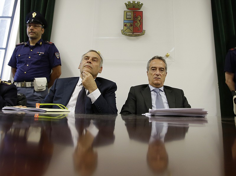 Italian prosecutors say two men behind a Twitter account that carried threats in the name of the Islamic State group were targeting an Italian military base near Brescia that has a U.S. military presence. Head of anti-terrorism unit Lamberto Giannini, left, and Prosecutor Maurizio Romanelli listen to a question during a news conference to illustrate an anti-terrorism operation, at the police headquarters in Milan, Italy, on Wednesday.