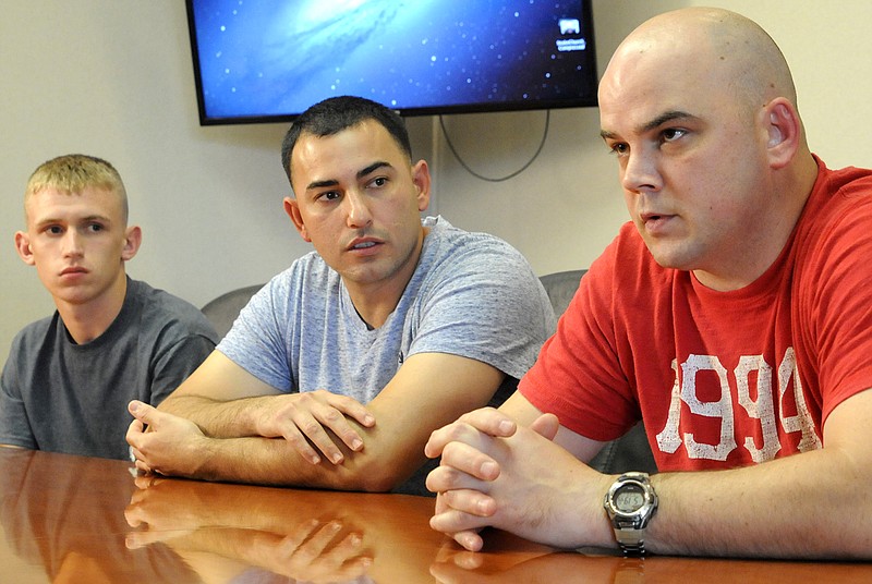 Marine Staff Sgt. Christopher "Chase" Estep, right, gives his account of what he and his men did during the July 16 attack on the U.S. Naval and Marine Reserve Center on Amnicola Highway. From left are Pfc. Aaron Noyes, Sgt. Jeff Cantu and Estep.