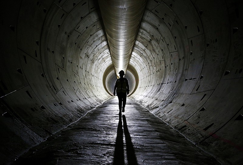 
              FILE - In this June 1, 2015, file photo, Robin Rockey, of the Southern Nevada Water Authority, walks through a tunnel still under construction beneath Lake Mead near Boulder City, Nev. The Conference Board reports on its index of leading economic indicators for June on Thursday, July 23, 2015. (AP Photo/John Locher, File)
            