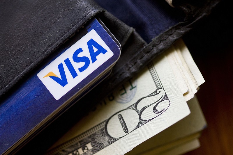 
              FILE - This Feb. 2, 2011 file photo shows a wallet containing cash and a Visa card in Surfside, Fla. Visa Inc. releases quarterly financial results on Thursday, July 23, 2015. (AP Photo/Wilfredo Lee, File)
            