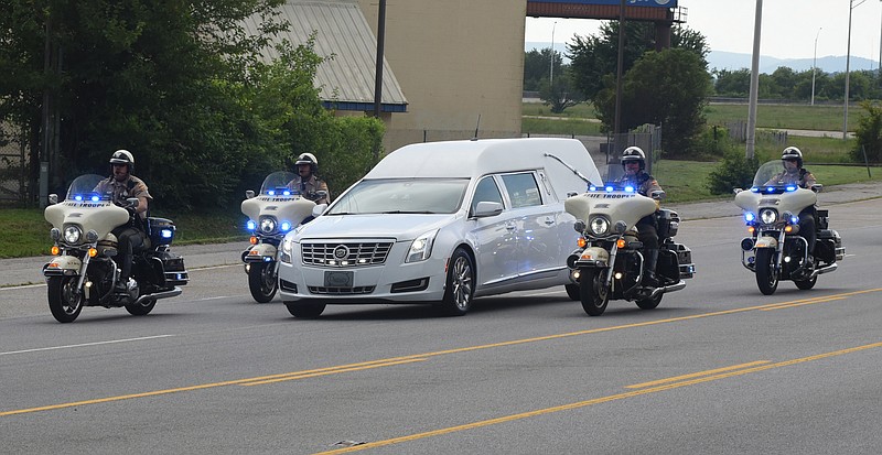 Members of the Tennessee Highway Patrol and the Chattanooga Police Department escort a hearse carrying the body of slain U.S. Navy Petty Officer 2nd Class Randall Smith on Amnicola Highway just past the U.S. Naval and Marine Reserve Center on July 19, 2015, in Chattanooga.