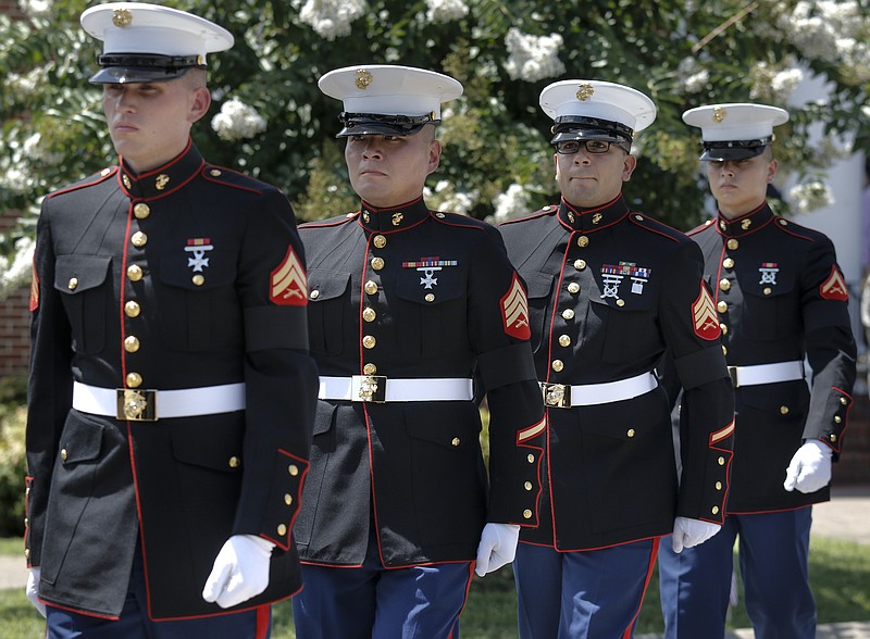 United States Marines who served as pallbearers walk to their vehicle after loading the casket of U.S. Marine Corps Staff Sgt. David Wyatt into a hearse outside of Hixson United Methodist Church after his funeral service Friday, July 24, 2015, in Hixson, Tenn. Staff Sgt. Wyatt was killed in the July, 16 shootings at the Naval Operational Support Center and Marine Corps Reserve Center on Amnicola Highway which left five dead, including shooter Mohammad Youssef Abdulazeez, and a Chattanooga police officer wounded.