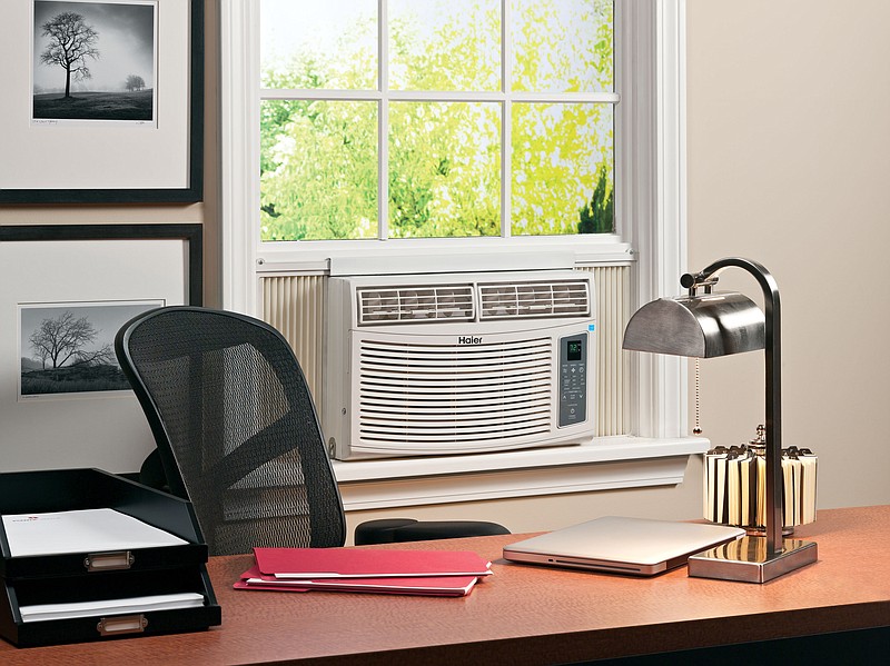 This photo provided by Haier America shows an Energy Star qualified room air conditioner in an office setting. A little savvy about when to open windows and when to keep them closed with curtains drawn goes a long way toward cooling a home, as does putting thought into what cooling appliances to use and when, the experts say. Make sure windows are well-sealed to keep cool air from leaking out.  (Haier America via AP)