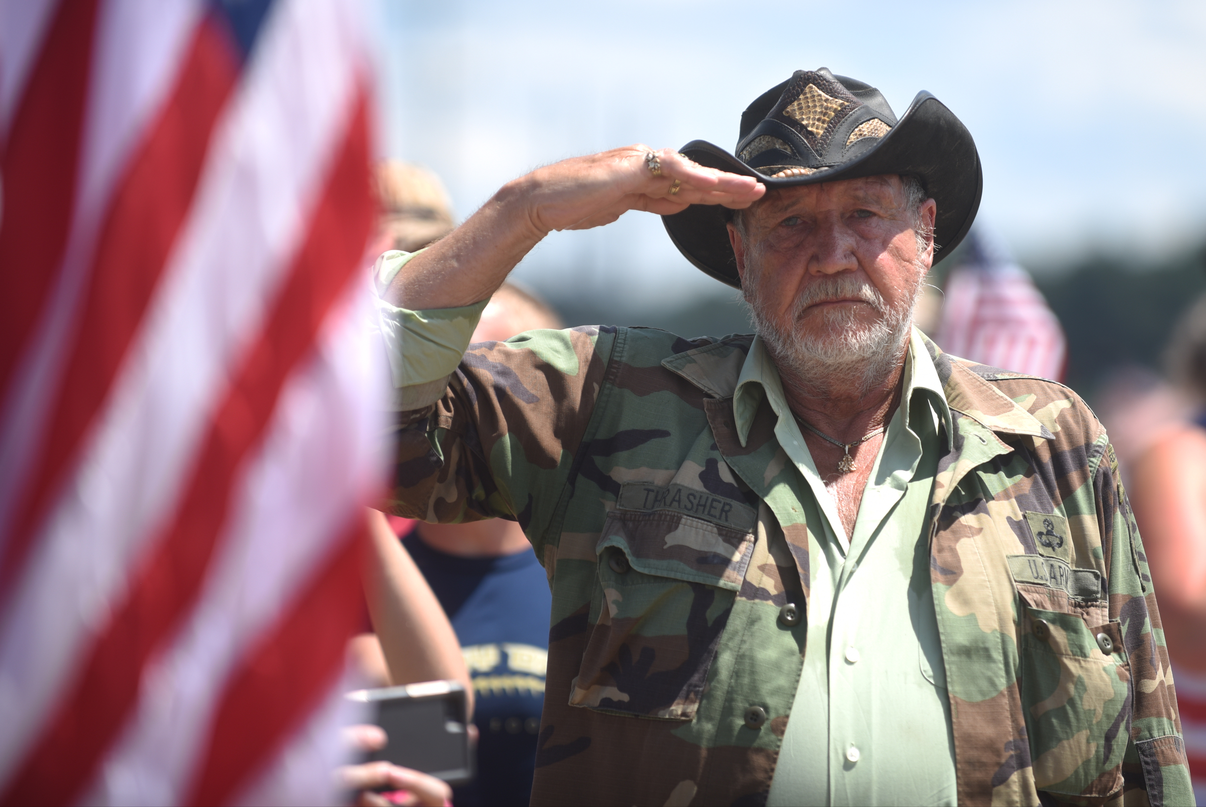 Special forces veteran Mike Thrasher salutes as vehicles travel down Highway 153 in Hixson, Tenn., Friday, July 24, 2015 after the funeral service for U.S. Marine Staff Sgt. David Wyatt. Wyatt was one of five servicemen whose death was the result of the second of two shootings carried out by Mohammad Youssuf Abdulazeez within a 30-minute span in Chattanooga, Tennessee, on July 16, 2015.
