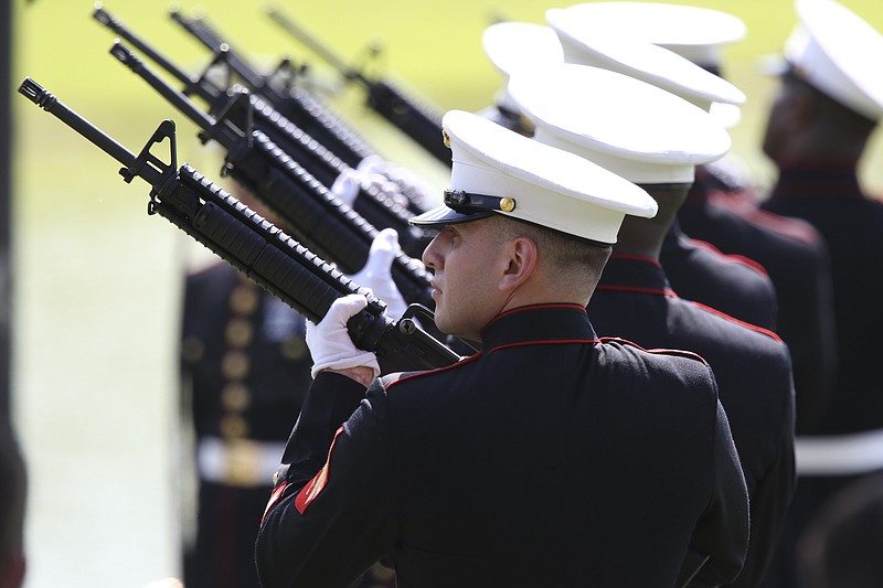 A 21-gun salute is fired off during the burial service for U.S. Marine Staff Sgt. David Wyatt at the Chattanooga National Cemetery on Friday, July 24, 2015. Wyatt was one of five servicemen whose death was the result of the second of two shootings carried out by Mohammad Youssuf Abdulazeez within a 30-minute span in Chattanooga, Tennessee, on July 16, 2015. 