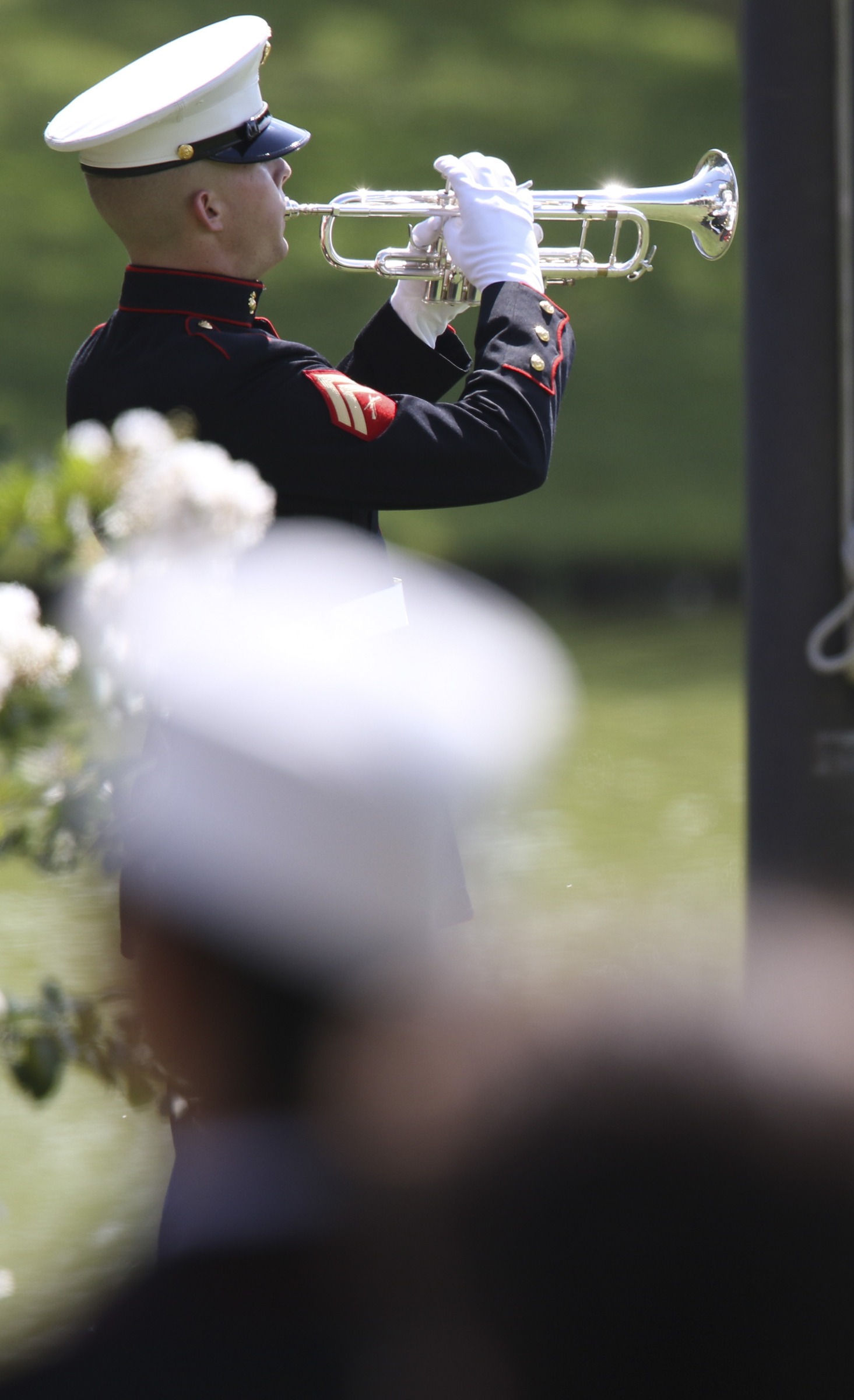 USMC Corporal Jordan Gardner plays taps during the burial service for U.S. Marine Staff Sgt. David Wyatt at the Chattanooga National Cemetery on Friday, July 24, 2015. Wyatt was one of five servicemen whose death was the result of the second of two shootings carried out by Mohammad Youssuf Abdulazeez within a 30-minute span in Chattanooga, Tennessee, on July 16, 2015.