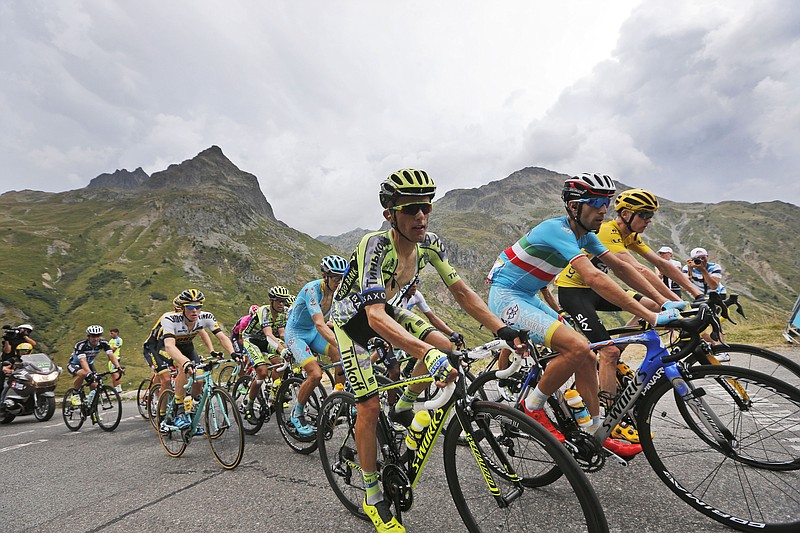 Britain's Chris Froome, wearing the overall leader's yellow jersey, stage winner Italy's Vincenzo Nibali, second right, and Poland's Rafal Majka, third right, climb during the nineteenth stage of the Tour de France cycling race over 85.7 miles with start in Saint-Jean-de-Maurienne and finish in La Toussuire, France, on Friday, July 24, 2015.