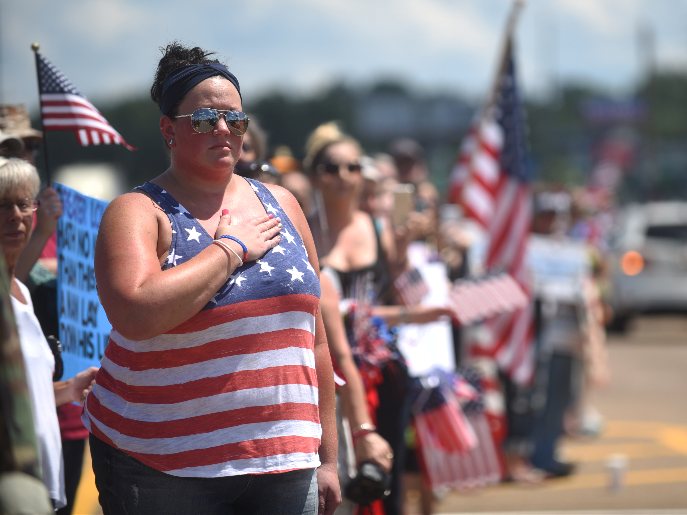 Amber Higgins watches vehicles travel down Highway 153 in Hixson Friday.