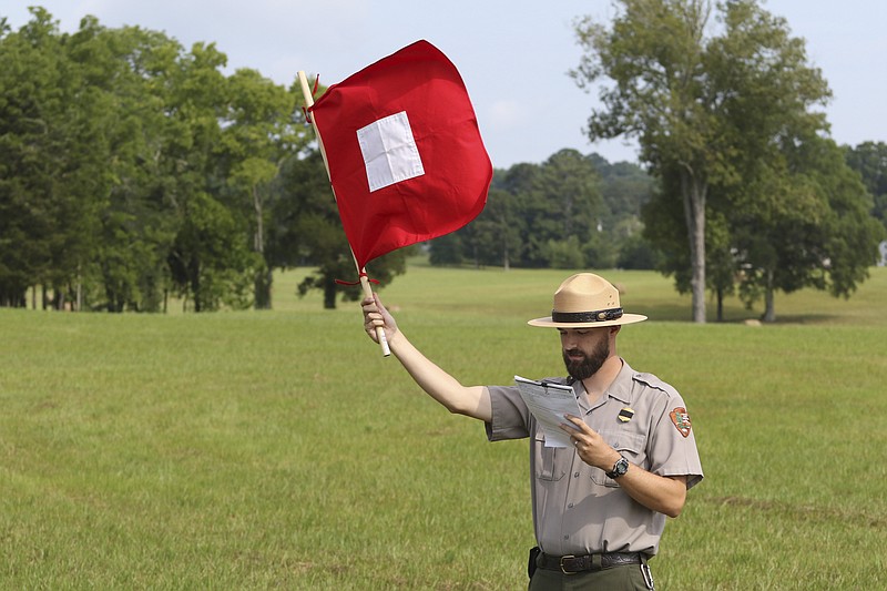 Chris Barr, left, sends a message to middle school students Wednesday while teaching them how to decipher Civil War-era signal flag movements during the "Call to Arms Summer Camp" at the Chickamauga and Chattanooga National Military Park.