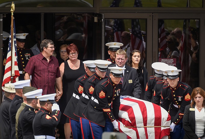 Members of the Marine Corps carry a casket with the remains of Sgt. Carson Holmquist, after a public visitation at Grantsburg High School in Grantsburg, Wis., Saturday, July 25, 2015. Holmquist was killed by a gunman in Chattanooga, Tenn. 