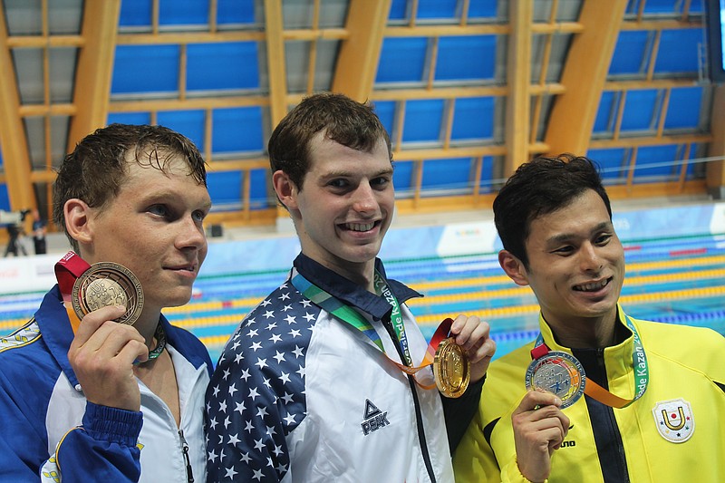 Sean Ryan, center, holds a gold medal he won in the 2013 World University Games in Kazan, Russia, in this file photo.