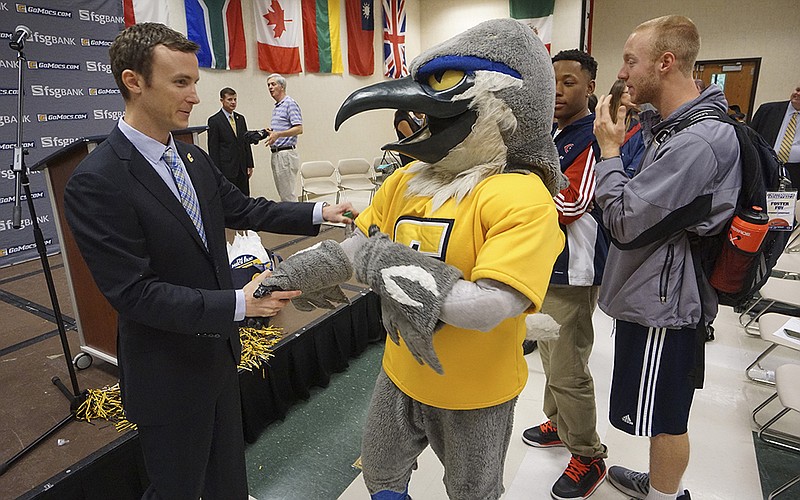 Matt McCall is greeted by University of Tennessee at Chattanooga mascot Scrappy after being announced as the Mocs' new head coach for men's basketball on April 14.