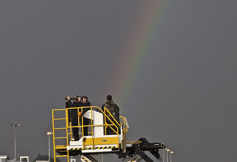 
              Secret Service Agents watch through their binoculars as a rainbow appears in the sky before President Barack Obama arrived at Bole International Airport, Addis Ababa, Ethiopia, Sunday, July 26, 2015.  Obama is traveling on a two-nation African tour where he will become the the first sitting U.S. president to visit Kenya and Ethiopia. (AP Photo/Sayyid Azim)
            