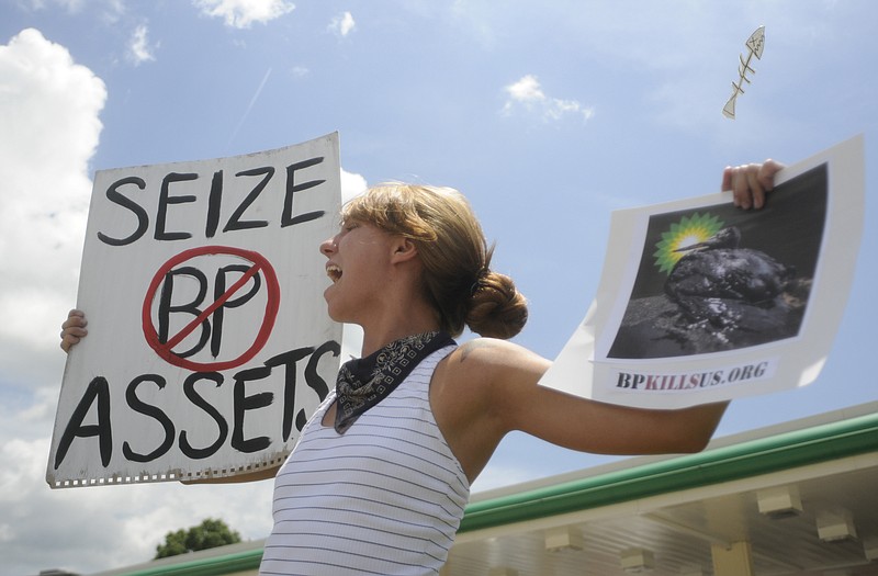 Chattanooga Times Free Press Ariel Bradley holds signs while protesting BP in front of the Kangaroo BP store on Hixson Pike in 2010.