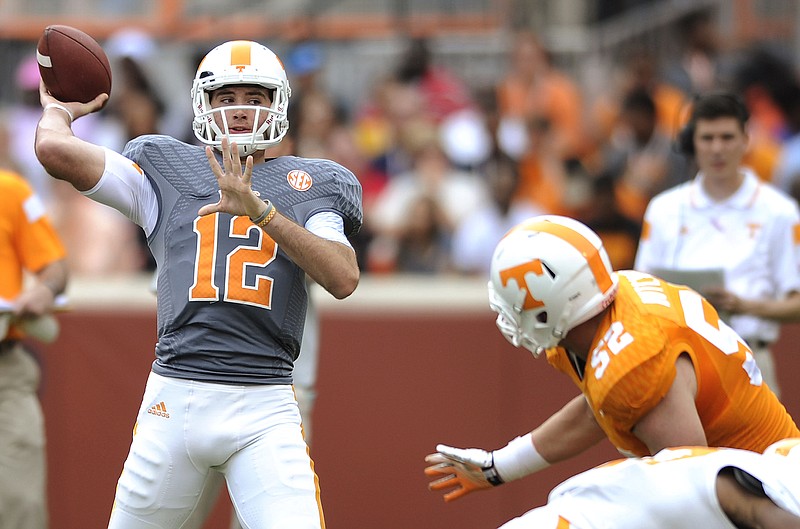Tennessee quarterback Quinten Dormady (12) looks to pass as defensive lineman Andrew Butcher (52) pursues during the NCAA college football team's Orange & White game at Neyland Stadium on Saturday, April 25, 2015, in Knoxville.