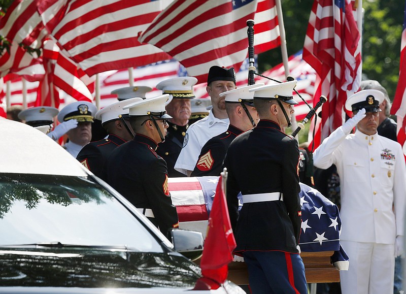 Marine pallbearers carry the casket of Marine Gunnery Sgt. Thomas Sullivan into a funeral service at Holy Cross Church in Springfield, Mass., Monday, July 27, 2015. Sullivan was one of five service members shot to death in the July 16 attack in Chattanooga. 