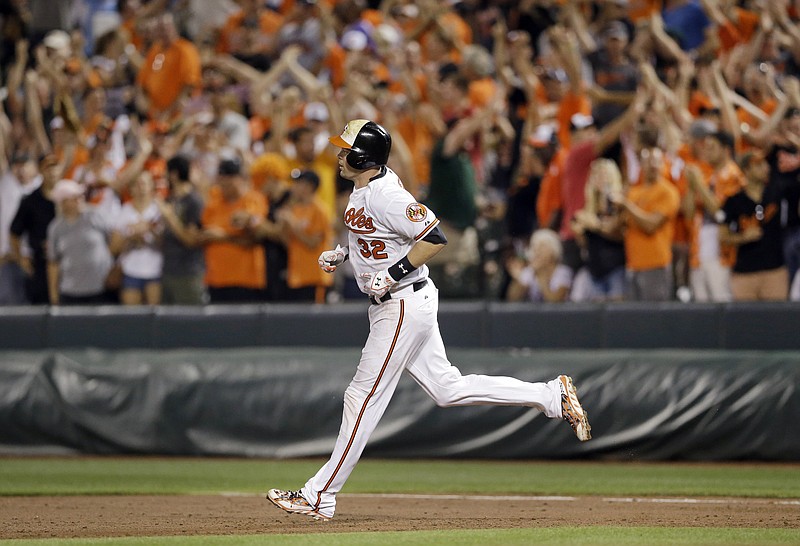 Baltimore Orioles' Matt Wieters rounds the bases after hitting a solo home run in the 11th inning of an interleague baseball game against the Atlanta Braves, Monday, July 27, 2015, in Baltimore. Baltimore won 2-1 in 11 innings. 