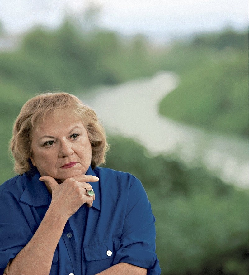 
              FILE - This July 2004 file photo shows, true-crime author Ann Rule, who wrote a book about serial killer Gary Ridgway, who left some of his victims' bodies along the Green River outside Seattle, Wash., shown in the background. Rule, who wrote more than 30 books, including a profile of her former co-worker, serial killer Ted Bundy, has died at age 83. Scott Thompson, a spokesman for CHI Franciscan Health, said Rule died at Highline Medical Center at 10:30 p.m. Sunday, July 26, 2015.  (Betty Udesen/The Seattle Times via AP, File) SEATTLE OUT; USA TODAY OUT; MAGS OUT; TELEVISION OUT; NO SALES; MANDATORY CREDIT TO BOTH THE SEATTLE TIMES AND THE PHOTOGRAPHER
            