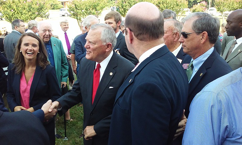 Georgia Gov. Nathan Deal shakes hands Tuesday morning outside the Murray County Courthouse as county Sole Commissioner Brittany Pittman (left) smiles.