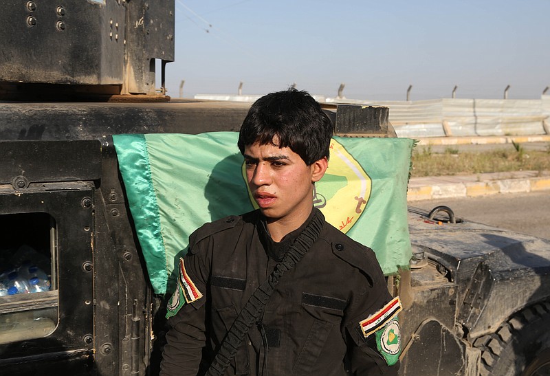 
              FILE - In this Sunday, March 15, 2015, file photo, a young Shiite volunteer militiaman stands near a vehicle on his way to the battlefield against Islamic State fighters in Tikrit, Iraq. The Associated Press has found that militia forces battling the Islamic State group are actively training children under 18 years old. (AP Photo/Khalid Mohammed, File)
            