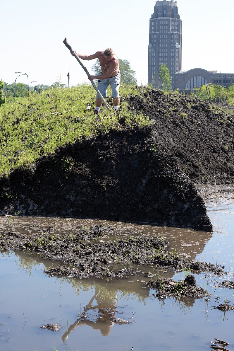 
              Robert A. Raczka uses a stick on top of this dirt-covered snow "glacier" that still hasn't melted at the Central Terminal on Buffalo's East side eight months ago, Tuesday, July 28, 2015. City crews dumped snow in the lots after a lake-effect storm dumped more than 7 feet on parts of Buffalo and the surrounding area the week before Thanksgiving. Eight months later, some of it is still there. (AP Photo/Gary Wiepert)
            