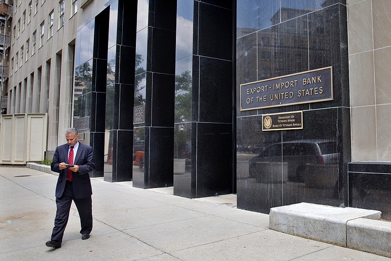 
              A man walks out of the Export-Import Bank of the U.S., Tuesday, July 28, 2015, in Washington. The federal Export-Import Bank expired June 30 when Congress failed to renew its charter. The bank is a small federal agency that helps U.S. companies sell their products overseas, by underwriting loans to foreign customers. Conservatives oppose it as corporate welfare and are pushing to keep it dead. But late Monday the Senate voted 64-29 to add legislation reviving the bank to a sweeping highway bill being considered on the floor. (AP Photo/Jacquelyn Martin)
            
