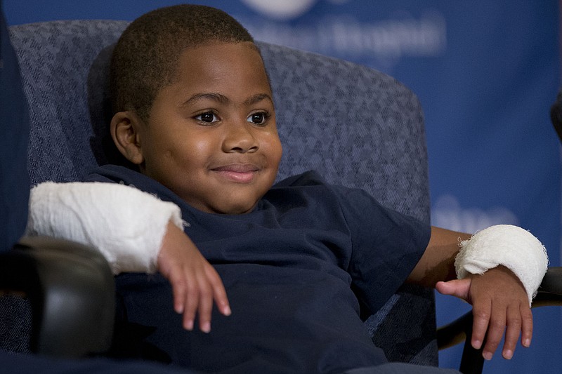 Double-hand transplant recipient eight-year-old Zion Harvey smiles during a news conference Tuesday, July 28, 2015, at The Children's Hospital of Philadelphia (CHOP) in Philadelphia.