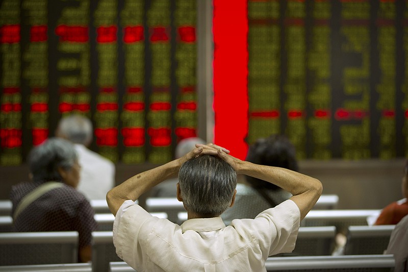 
              A Chinese investor monitors displays of stock information at a brokerage house in Beijing, Tuesday, July 28, 2015. Shanghai stocks were volatile Tuesday after falling the most in eight years the day before while other Asian markets also flitted between gains and losses. (AP Photo/Mark Schiefelbein)
            