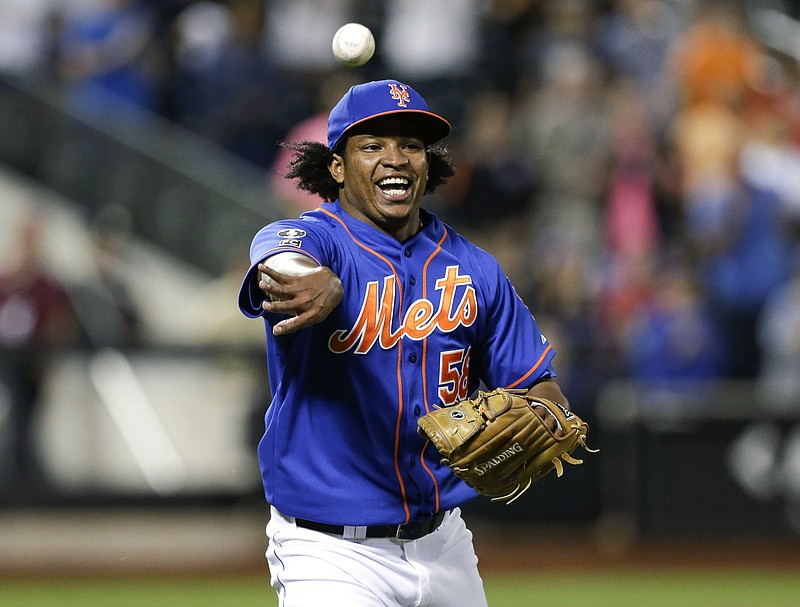 In this Wednesday, Sept. 10, 2014, file photo, New York Mets relief pitcher Jenrry Mejia tosses the ball to throw out Colorado Rockies' Josh Rutledge at first base to end a baseball game, in New York.