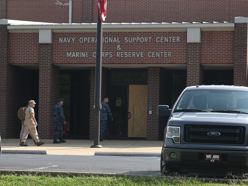 Servicemen in uniform prepare to enter the U.S. Naval and Marine Reserve Center on Wednesday after officials reopened the Riverpark recreation area late Tuesday evening.